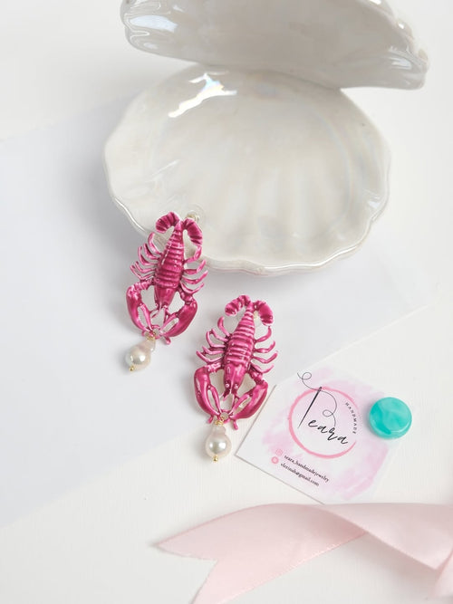 Detail shot of hypoallergenic ocean-themed earrings featuring organic baroque nuclear pearls.