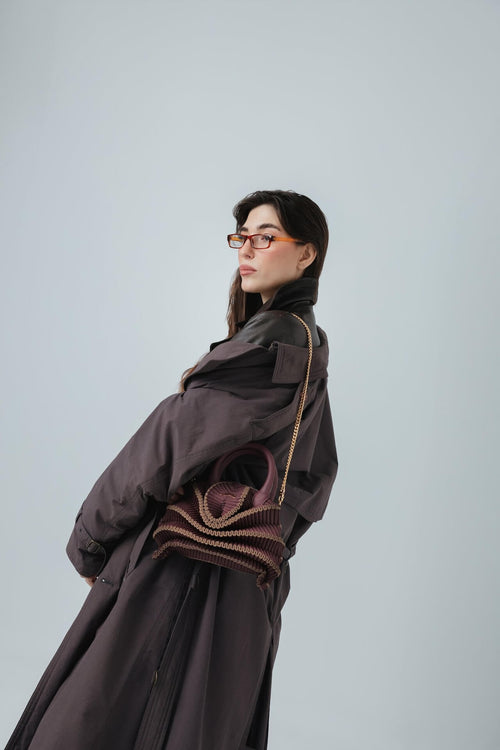 Model trägt die gestrickte Balom Attesa Leder Handtasche mit Kette in Champagne Party in der Vorderansicht