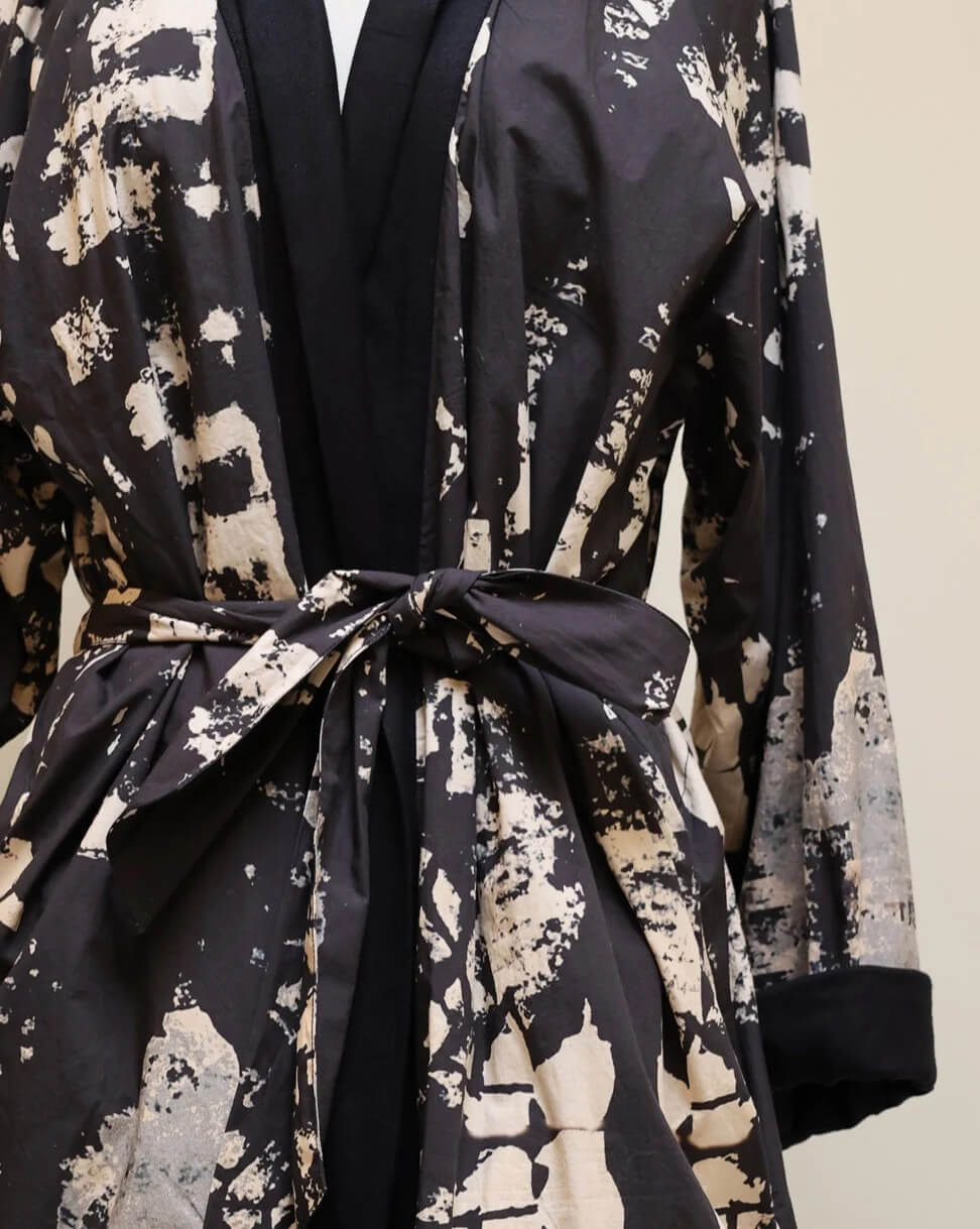 Detailed close up shot of the fine art painting print and woven trim on Jacket 006