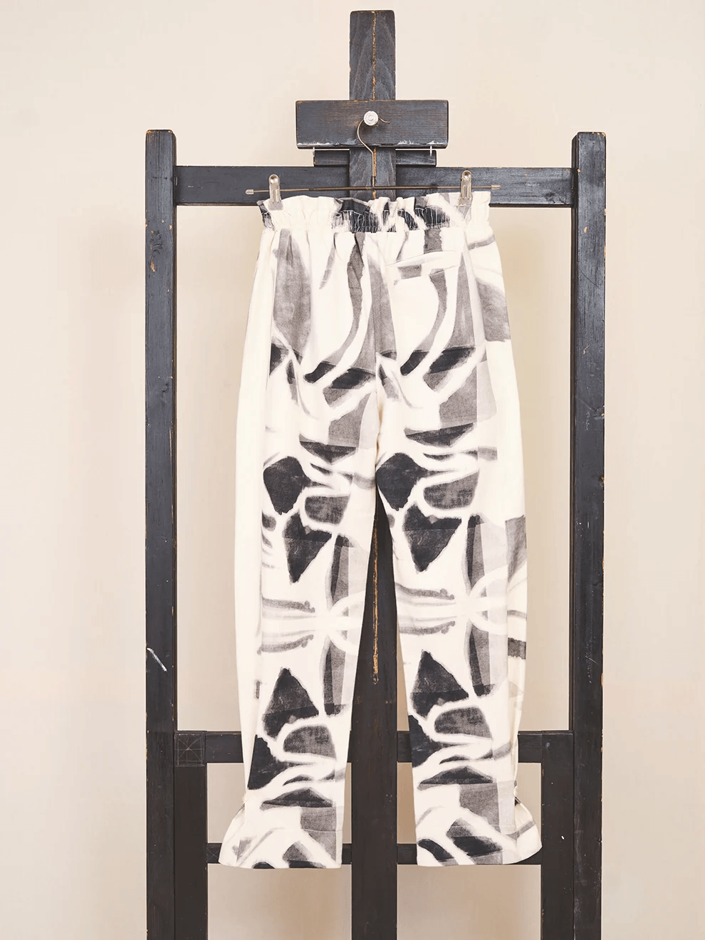 Close up of the custom woven accent details on the bottom hem of the Pants 001 organic cotton trousers