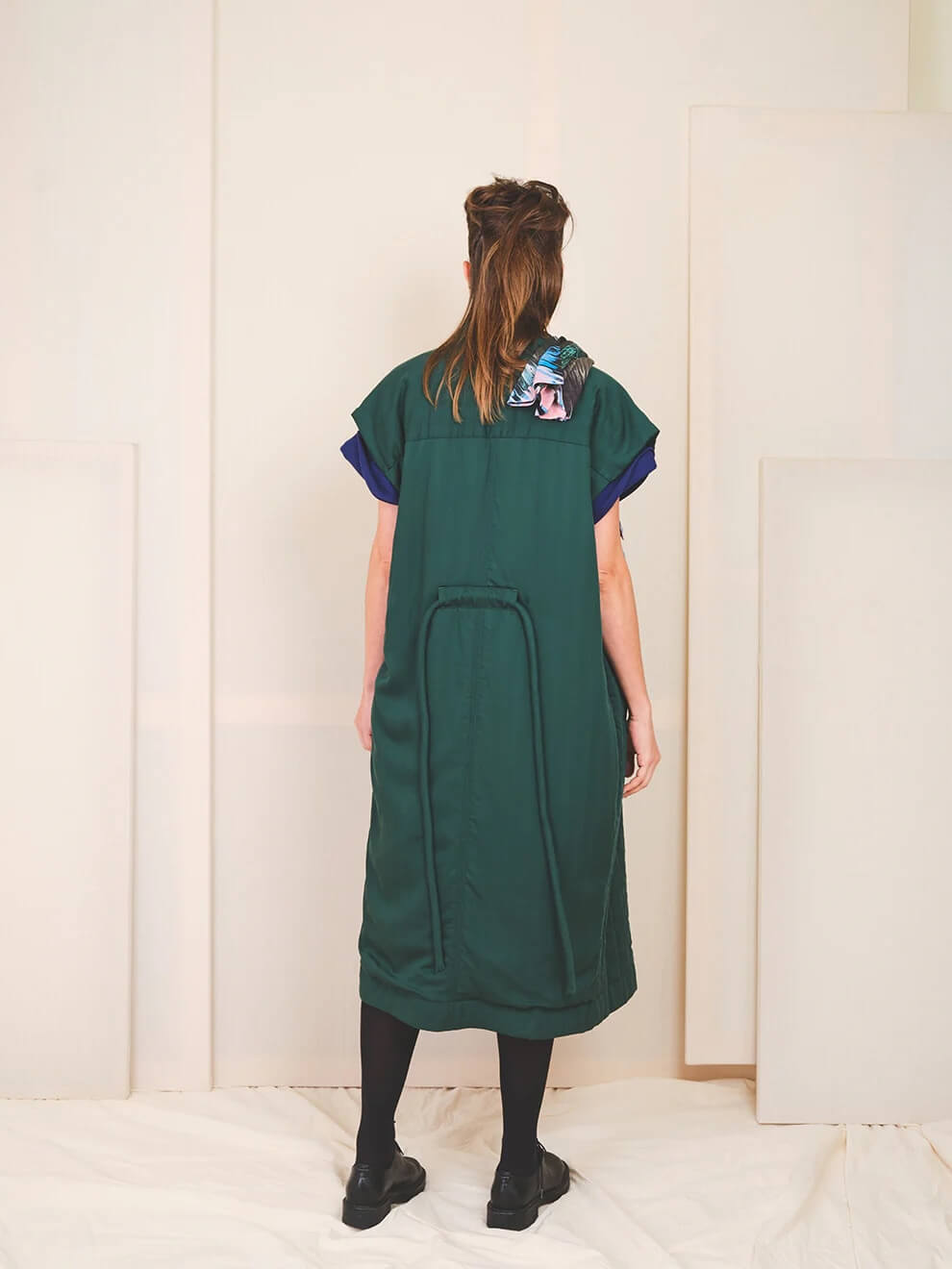 Back view of the limited capsule Veste 009 longline vest showing the signature removable waist belt detail